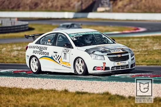 White Chevy Cruze race car in motion on track